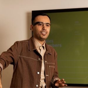 Man in classroom wearing Envision glasses