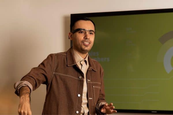 Man in classroom wearing Envision glasses