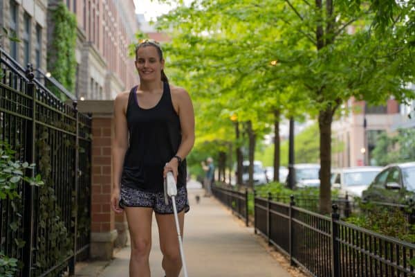 a woman athlete walking with WeWALK
