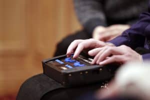 Hands using a Braille notetaker