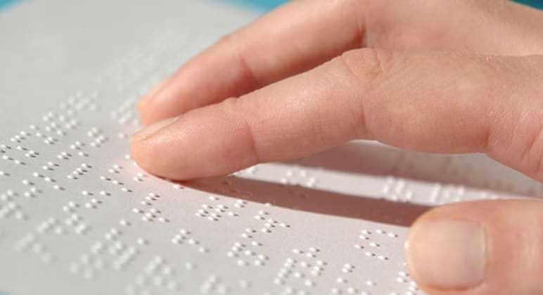 Hands reading Braille