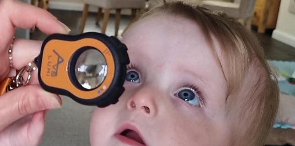 Image of Lumio being held over a baby's eye