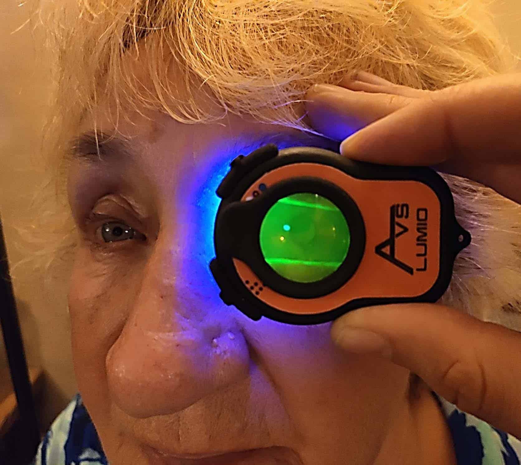 Photo of Lumio held in front of lady's eye